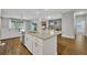 Stylish kitchen island with granite countertops, stainless steel sink, and ample cabinet space at 16259 Misty Hills Ave, Winter Garden, FL 34787