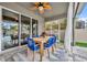 Relaxing patio with dining table, a decorative fan, and privacy screening at 16259 Misty Hills Ave, Winter Garden, FL 34787