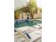 Backyard pool with cascading water feature, deck chairs, and lush tropical landscaping at 16259 Misty Hills Ave, Winter Garden, FL 34787