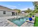 Backyard pool with integrated lounge chairs, landscaped garden, and covered patio at 16259 Misty Hills Ave, Winter Garden, FL 34787