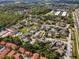 An aerial view shows condos surrounded by lush green trees and shrubs, with nearby highway access at 166 Scottsdale Sq # 166, Winter Park, FL 32792