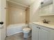 Cozy bathroom featuring tiled walls, a shower and tub combo, and a white vanity at 166 Scottsdale Sq # 166, Winter Park, FL 32792