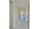 Hallway with tile floor and a closet leading to a bright living space at 166 Scottsdale Sq # 166, Winter Park, FL 32792