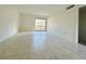 Bright living room with tile floors and sliding glass doors to the outside at 166 Scottsdale Sq # 166, Winter Park, FL 32792