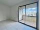 Living room featuring tile floors and sliding glass doors leading to a balcony at 166 Scottsdale Sq # 166, Winter Park, FL 32792