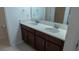 Bathroom featuring double sinks, spacious countertop, and wood cabinets at 1740 Deans Crossing Ln, Orlando, FL 32825