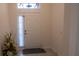 Bright foyer featuring neutral tile floors and a stylish front door with transom window at 1740 Deans Crossing Ln, Orlando, FL 32825