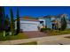 Attractive single-Gathering house boasting a brick driveway, two-car garage, and lush landscaping at 1740 Deans Crossing Ln, Orlando, FL 32825