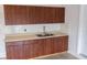 This kitchen features wood cabinets with a double sink and neutral countertops at 1740 Deans Crossing Ln, Orlando, FL 32825