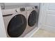 Modern laundry room featuring a side-by-side washer and dryer for convenient chores at 1740 Deans Crossing Ln, Orlando, FL 32825