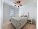 Cozy bedroom featuring a decorative ceiling fan, plush carpet, and a window with blinds at 209 Silver Maple Rd, Groveland, FL 34736