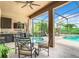 Screened outdoor area with kitchen, seating, and view of the pool at 2281 The Oaks Blvd, Kissimmee, FL 34746