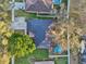 This aerial view features a backyard pool, lush greenery, a driveway, and a well-maintained roof at 2294 Lakeview Ave, Clermont, FL 34711