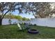 Relaxing backyard featuring a fire pit with chairs and string lights draped from the trees at 2294 Lakeview Ave, Clermont, FL 34711