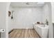 Bathroom with walk-in shower featuring stylish fixtures and floor-to-ceiling textured tile at 2294 Lakeview Ave, Clermont, FL 34711