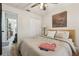 Comfortable bedroom features a ceiling fan and view of the closet and ensuite at 2294 Lakeview Ave, Clermont, FL 34711