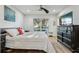 Sunlit bedroom featuring a ceiling fan, window, and dresser at 2294 Lakeview Ave, Clermont, FL 34711