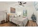 Cozy bedroom boasts a ceiling fan, window shutters, and plenty of natural light at 2294 Lakeview Ave, Clermont, FL 34711