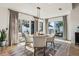 Bright dining area with stylish light fixture, wood floors, and sliding door access to the outdoor space at 2294 Lakeview Ave, Clermont, FL 34711