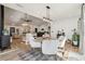 Cozy dining area with modern lighting, wood-look floors, and neutral decor at 2294 Lakeview Ave, Clermont, FL 34711