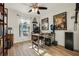 Bright home office with natural light, hardwood floors, ceiling fan, and decorated with geeky collectibles at 2294 Lakeview Ave, Clermont, FL 34711