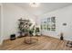 Bright living room featuring modern furniture, wood floors, and large window with shutter blinds at 2294 Lakeview Ave, Clermont, FL 34711