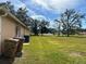 Spacious grassy backyard featuring mature trees, enhancing outdoor space at 231 Cranbrook Dr, Kissimmee, FL 34758