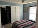 Cozy bedroom with a striped bedspread, a closet and a window with blinds at 231 Cranbrook Dr, Kissimmee, FL 34758