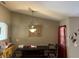 Cozy dining area showcases a dark wood table and bench, highlighted by an elegant light fixture at 231 Cranbrook Dr, Kissimmee, FL 34758