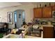 View of kitchen with a double sink, wooden cabinets, an island, and dining area in the background at 231 Cranbrook Dr, Kissimmee, FL 34758