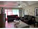 Bright living area with comfortable couches, a ceiling fan, and soft lighting at 231 Cranbrook Dr, Kissimmee, FL 34758