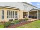 Inviting backyard with raised garden beds, lush lawn, and direct access to the screened patio at 2362 Blossomwood Dr, Oviedo, FL 32765