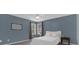 This bedroom includes a bed, two windows for light, and neutral-colored walls at 2362 Blossomwood Dr, Oviedo, FL 32765