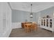 Charming dining room with modern light fixture, plantation shutters, and wood-look floors at 2362 Blossomwood Dr, Oviedo, FL 32765