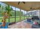 The screened patio features tile flooring, ceiling fans, and views of the backyard at 2362 Blossomwood Dr, Oviedo, FL 32765