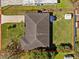 Aerial view showcasing the house, its well-maintained roof, the driveway, and expansive backyard at 2405 Janet St, Kissimmee, FL 34741