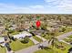 Aerial view of a residential neighborhood showcasing property and surrounding area with mature trees at 2405 Janet St, Kissimmee, FL 34741