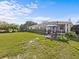 Expansive backyard with a patio, lawn, and privacy hedges at 2405 Janet St, Kissimmee, FL 34741