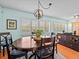 Dining room features a dark wood table, chairs, and a decorative chandelier at 2405 Janet St, Kissimmee, FL 34741