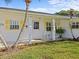 Inviting front entrance with white rocking chairs and yellow shutters accenting this well maintained home at 2405 Janet St, Kissimmee, FL 34741