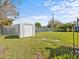 Backyard storage shed with fencing, providing additional storage and organization in a spacious yard at 2405 Janet St, Kissimmee, FL 34741