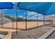 Community baseball field with shaded bench and chain-link fencing on a sunny day with a bright blue sky and white, fluffy clouds at 2604 Hollow Ln, Leesburg, FL 34748