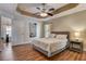 Bedroom boasts a tray ceiling, ceiling fan, and luxury vinyl flooring at 2604 Hollow Ln, Leesburg, FL 34748