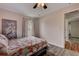 Bedroom showcases a serene ambiance with wood-look floors and natural light from the window at 2604 Hollow Ln, Leesburg, FL 34748