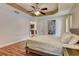 Bedroom with tray ceiling, ceiling fan, and luxury vinyl flooring at 2604 Hollow Ln, Leesburg, FL 34748