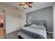 Bedroom showcasing gray walls, wood-look floors, a ceiling fan, and a comfortable bed at 2604 Hollow Ln, Leesburg, FL 34748