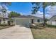 Well-maintained home featuring a two-car garage, stone accents, and a neatly landscaped front yard at 2604 Hollow Ln, Leesburg, FL 34748