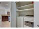 Laundry closet featuring a washing machine, dryer, and shelving at 2604 Hollow Ln, Leesburg, FL 34748