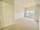 Spacious carpeted bedroom with ample closet space and natural light streaming through the window at 2605 Gala S Rd # 103, Kissimmee, FL 34746