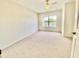 Bright bedroom features neutral walls, carpet, a ceiling fan and a large window offering great views at 2605 Gala S Rd # 103, Kissimmee, FL 34746